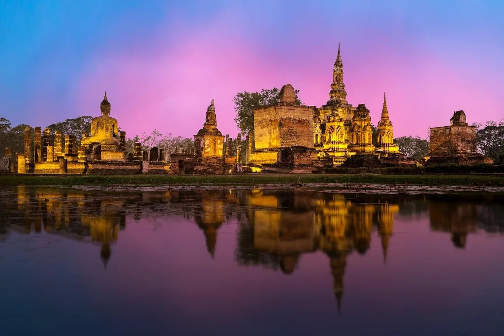 Tomorrowland Thailand 2026: Ayutthaya temples lit at dusk and reflected in the water